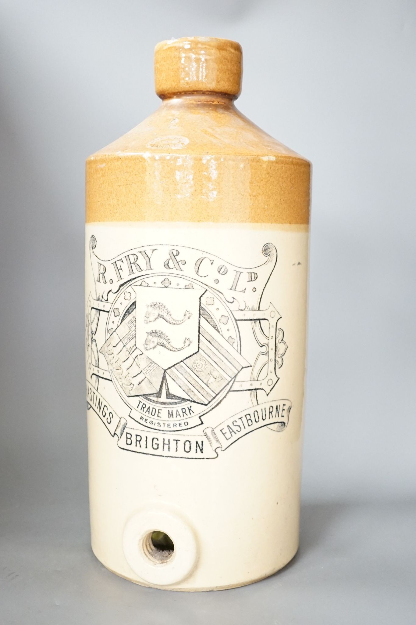A stoneware bottle, R Fry & Co Ltd, Hastings, Brighton and Eastbourne, stamped Doulton Lambeth, 47 cms high.